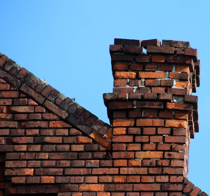 Damaged chimney on an Little Elm home showing cracks and missing mortar